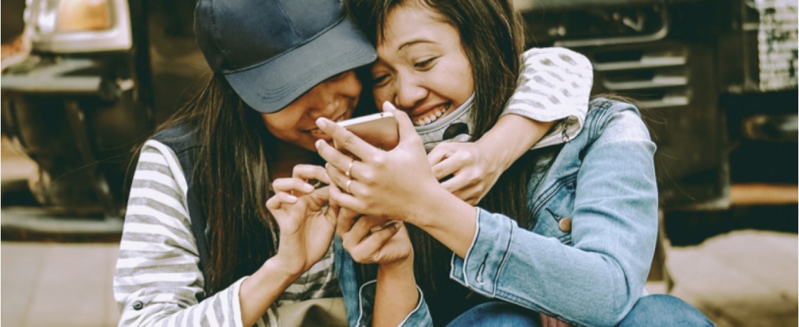 Girls reading articles while laughing
