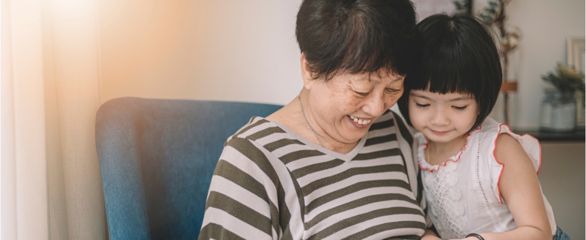 Grandmother and grandchild looking at tablet