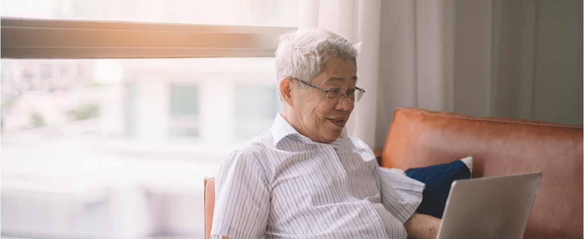 Senior man browsing his laptop